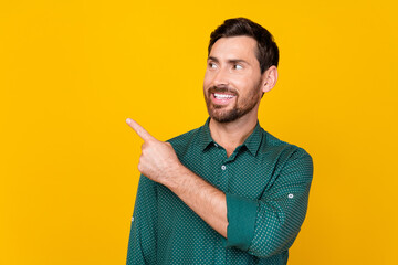 Portrait of toothy beaming guy with beard wear stylish shirt look indicating at logo empty space...