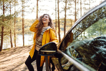 Female driver enjoying freedom and beautiful nature. The concept of traveling by car, active lifestyle.