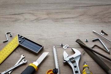 A set of hand tools on a wooden background. The concept of repair work. Copy space - obrazy, fototapety, plakaty