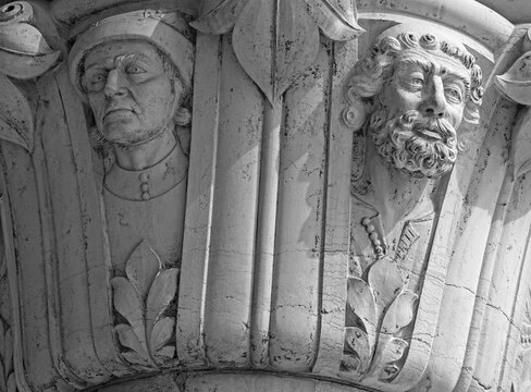 Venice, Italy, Sept. 17, 2023: The detailed heads of two men on a Doge’s Palace portico column show the skill of the city’s medieval Stone-Carvers Guild. 