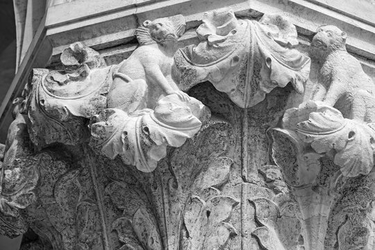 Venice, Italy, Sept. 17, 2023: On a Doge’s Palace column capital, two impish monkeys amid ornate leaves show the imagination and skill of the city’s medieval stone carvers.
