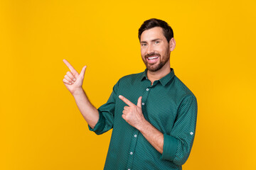 Portrait of cool positive guy with beard wear stylish shirt indicating at discount empty space...