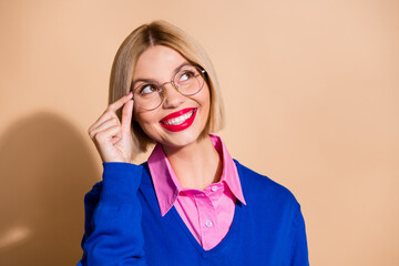 Photo of lovely creative minded lady arm touch eyeglasses look empty space contemplate isolated on beige color background