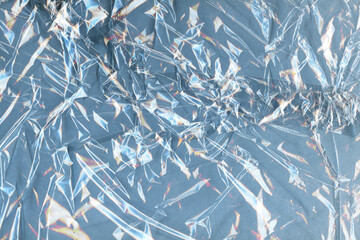 Cellophane Grungy Background for design. Transparent Crumpled Plastic Textures contrasted against...