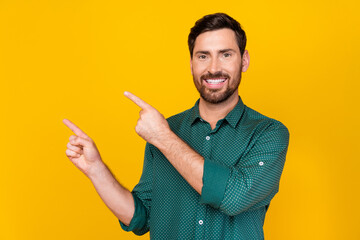 Portrait of optimistic nice guy with beard wear stylish shirt look indicating at empty space...
