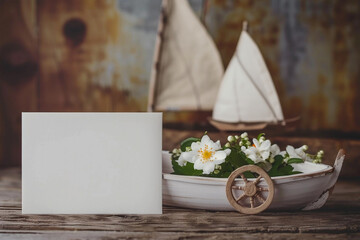 Empty blank note with toy wooden sailinh boat and steering wheel on rustic background - 742938776