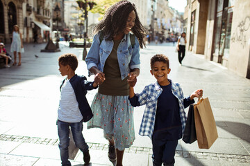 Mother and sons walking in the city and shopping