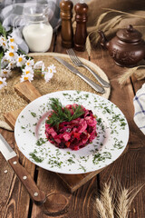 salad vinaigrette beautiful serving on a white plate on a wooden background