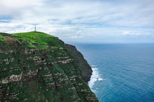 View of vibrant coast line near Ponta do Pargo, where ocean meets cliffs, on Madeira island, Portugal