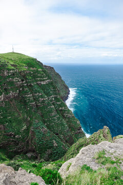 View of vibrant coast line near Ponta do Pargo, where ocean meets cliffs, on Madeira island, Portugal