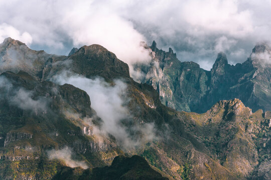View of rough mountain peaks partially covered by clouds, Madeira Island, Portugal