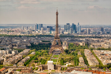 View of the Eiffel tower in Paris downtown, view of the financial district with skyscrapers in background, France.