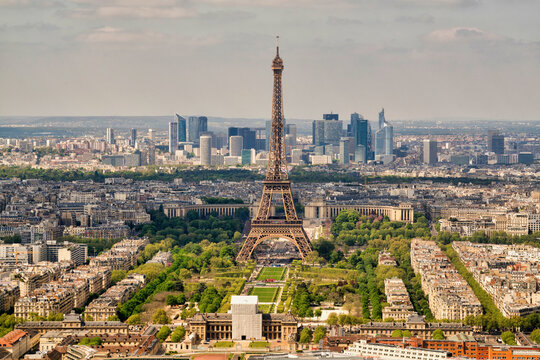View of the Eiffel tower in Paris downtown, view of the financial district with skyscrapers in background, France.