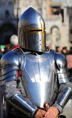 medieval knight with steel armor and helmet to protect his head
