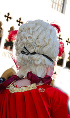white wig of the lady in mask during the Venice Carnival celebrations in Italy and the ancient...