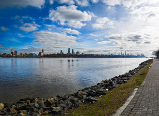  Clear blue skies over the modern skyline of Upper Manhattan, viewed from the serene shores of Edgewater, NJ.