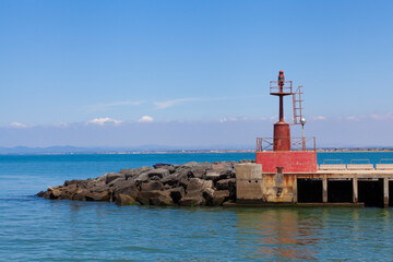 Weathered dock end at Fiumicino port, mini lighthouse signaling ships. - 742977106