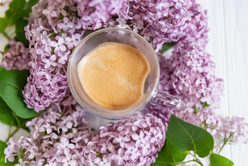 freshly brewed cup of coffee among vibrant lilac blossoms, capturing essence of tranquil spring morning - 742977309