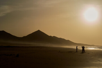 Sunset on Cofete beach in Fuerteventura in Jandia Natural Park with silhouettes and mountains