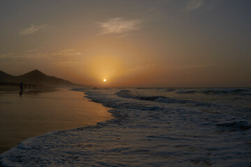Sunset on Cofete beach in Fuerteventura in Jandia Natural Park with silhouettes and mountains