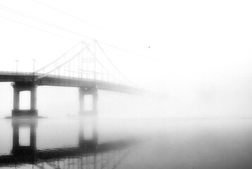 The waterfront lies deserted, engulfed in a thick blanket of fog that obscures the view of the...