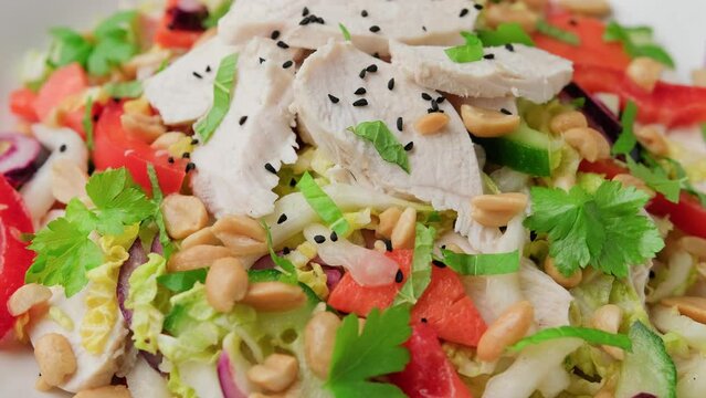 Healthy Vietnamese Chicken Salad with vegetables and peanuts. Rotating video