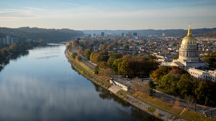West Virginia's Capitol Glows at Sunrise, Kanawha River Reflects - obrazy, fototapety, plakaty