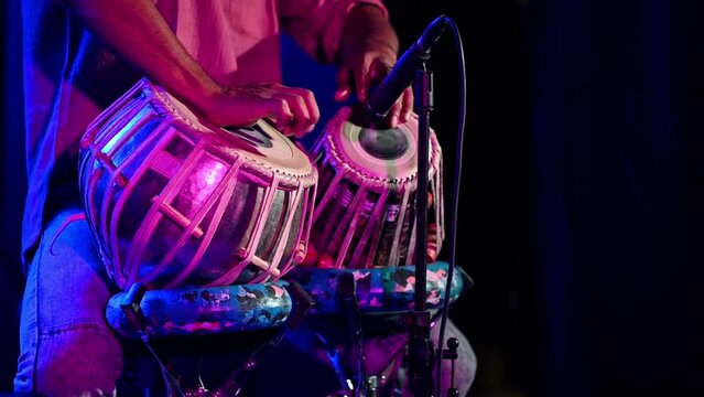 Close up shot of person seen playing the tabla