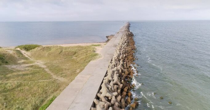 Aerial drone shot of a breakwater on Baltic sea coast in Liepāja, Latvia. Aerial drone shot.
