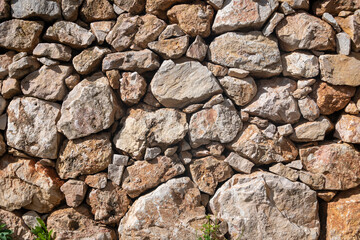 textured dry stone wall, close up section.