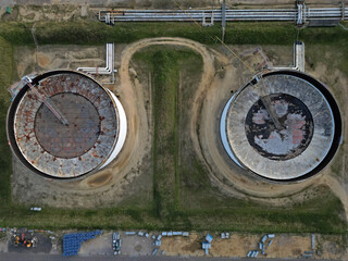 Two oil storage tanks connected with the road track and pipelines. Top down aerial view.