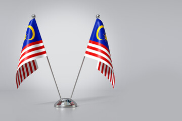Double Malaysia Table Flag on Gray Background. 3d Rendering