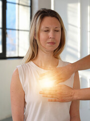 Woman enjoying Energy healing treatment . Heart Chakra Balancing, unconditional love, compassion