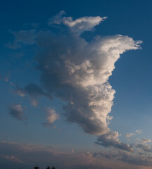 Beautiful large cloud against the blue sky, panoramic photo of a white fluffy cloud