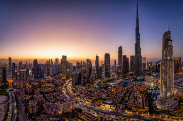 Fototapeta na wymiar Panoramic view of the illuminated Downtown district skyline of Dubai, UAE, with the modern Skyscrapers and traditional buidings during dusk