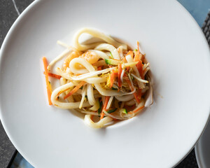 Stir-fried Yaki Udon noodles with shrimps fish, vegetables and soy-based Sauce. Japanese food. Top view