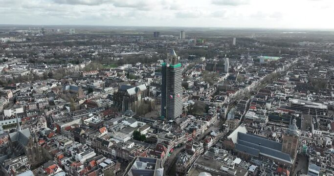 Aerial drone view on the Utrecht Cathedral in scaffolding for renovation. Gothic church in the middle of the Dutch city of Utrecht . Monument and city centre landmark.