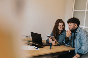 Young enthusiastic coworkers discussing strategies for successful collaboration and problem-solving...