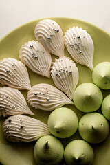 White and lime meringue on a round plate