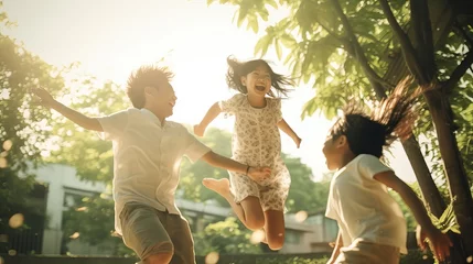 Fototapeten Rear view of joyful happy Asian family jumping together at outdoor park © Elchin Abilov