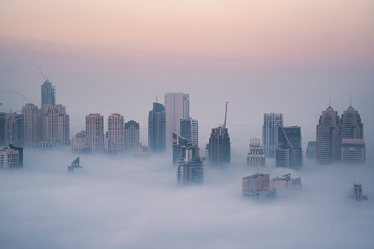 Aerial view of Dubai Marina at dawn with foggy sky, Dubai, United Arab Emirates.