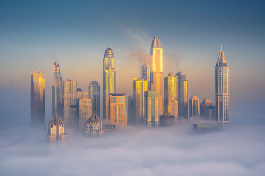 Aerial view of Dubai Marina at sunrise with Cayan Tower, Dubai, United Arab Emirates.