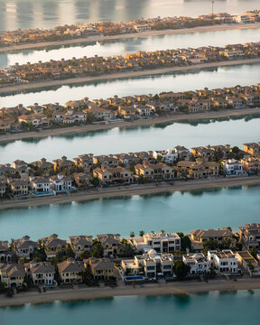 Aerial view of Dubai with geometric structures and luxurious homes on the exclusive Palm Jumeirah island, United Arab Emirates.