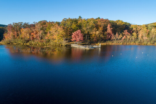 Aerial view of Lower Twin Lake in autumn with colorful foliage, New York, United States.