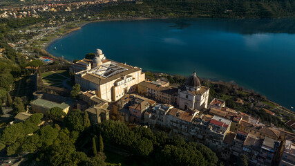 Aerial view of the Papal Palace of Castel Gandolfo, near Rome, Italy. The Apostolic Palace is a complex of buildings served for centuries as a summer residence for the Pope. It overlooks Lake Albano.  - obrazy, fototapety, plakaty