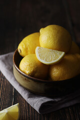 A bowl with yellow bright lemons	