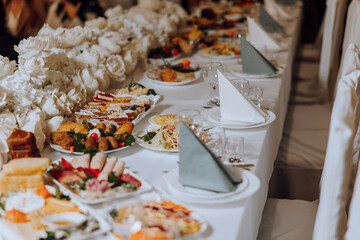 Top view of a beautifully decorated table with delicious food. Everything is ready for lunch or dinner with delicious snacks and a cozy atmosphere.