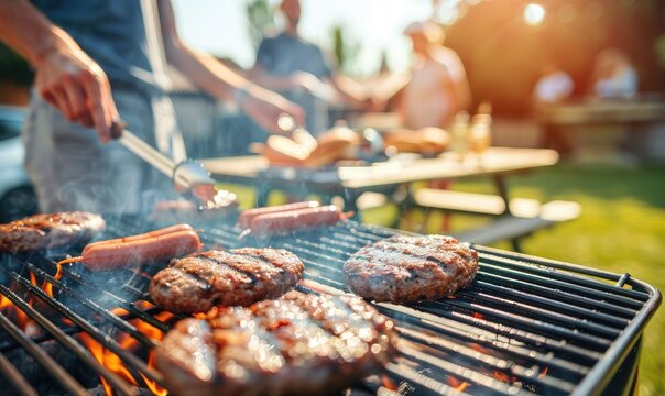 A group of friends grilling burgers and hot dogs having a BBQ in a backyard