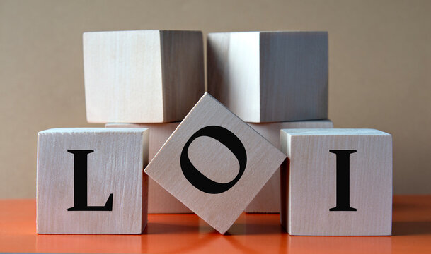 LOI - acronym on large wooden cubes on light brown background
