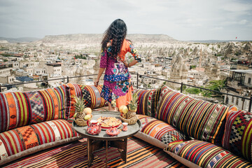 woman witn Traditional turkish breakfast with Cappadocia view. Goreme, Turkey.